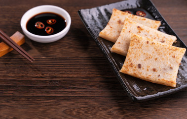 Delicious turnip cake, Chinese traditional local dish radish cake in restaurant with soy sauce and...