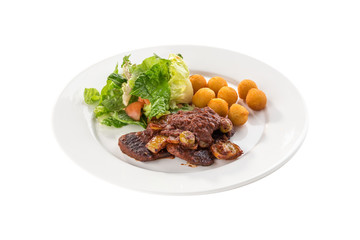 Grilled steak with green salad and fried potato balls isolated on white background