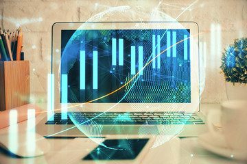 Financial market graph hologram and personal computer on background. Double exposure. Concept of forex.