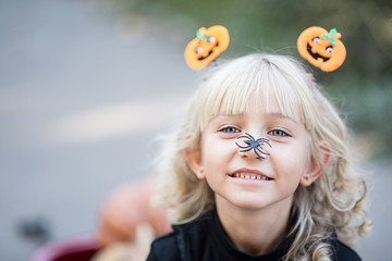 little girl in witch costume celebrate Halloween outdoor and have fun.
