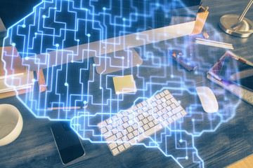Double exposure of table with computer and brain hologram. Data innovation concept.