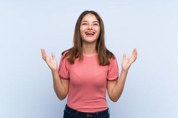 Fototapeta premium Young brunette girl over isolated blue background laughing