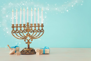 Religion image of jewish holiday Hanukkah background with menorah (traditional candelabra) and dreidels