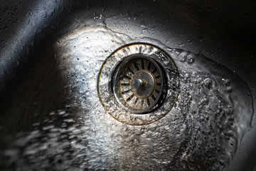 Water flowing and splashing in sink, Light and shadow, Close up & Macro shot, Selective focus, Healthcare concept
