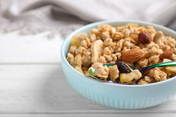 Tasty homemade granola on white wooden table. Healthy breakfast