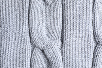 Warm knitted sweater as background, closeup view