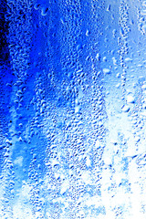 Drops on glass on a blue background