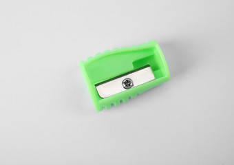 Modern green pencil sharpener on white background