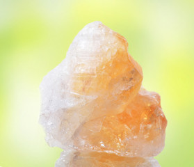 macro shooting of natural mineral rock specimen -  citrine stone on an isolated ,reflection