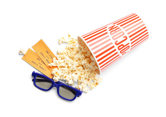 Bucket of fresh popcorn, tickets and 3D glasses on white background, top view. Cinema snack