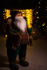 Santa Claus carrying big bag full of gifts, at home near Christmas Tree