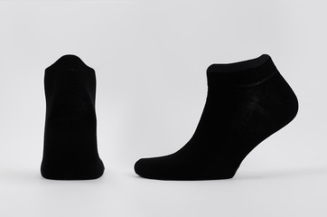 Blank black cotton short socks on invisible mannequin foot as mock up for advertising, branding,...