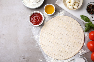 Flat lay composition with fresh ingredients for pizza Margherita on grey table