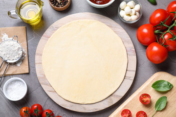 Flat lay composition with fresh ingredients for pizza Margherita on grey table