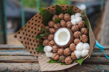 A bouquet of walnuts and coconut with natural cotton flowers. Edible bouquet. Close-up