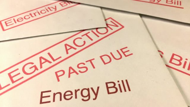 Hardship And Debt. Tilt Down Over A Of A Pile Of Unpaid Energy Gas And Electricity Bills With A Threat Of Legal Action.itled