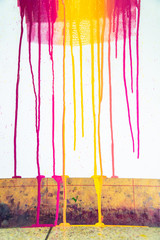 colors of printing ink purple, pink, orange, yellow and magenta colors are dripping on white paper.