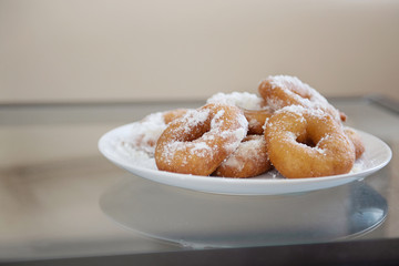 donuts on a plate in powdered sugar