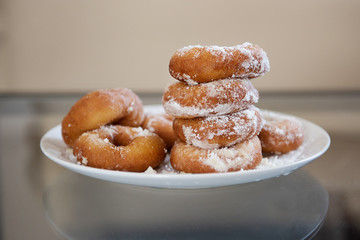 donuts on a plate in powdered sugar
