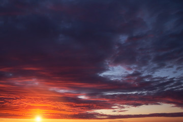 Fototapeta na wymiar Epic dramatic sunset, sunrise orange sky with clouds, sun and sunlight 