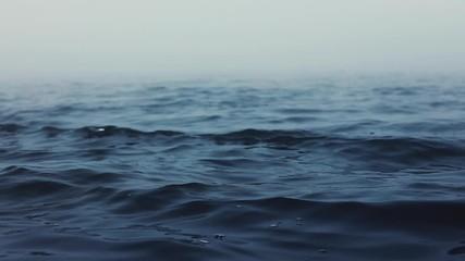 Sea waves. Fog above blue ripple water
