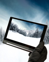 Black table in hands and winter background 
