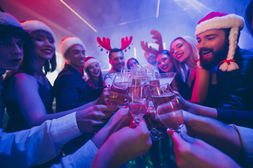 Cropped photo of best friends company corporate party holding sparkling wine glasses counting seconds newyear wear dresses shirts pants santa hat in night club