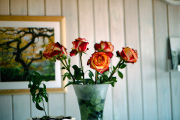 Roses in a vase on the bedside table