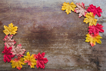 Naklejka na ściany i meble Autumn leaves on wooden background with copy space. Wallpaper for September thanksgiving.