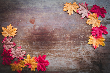 Naklejka na ściany i meble Autumn leaves on wooden background with copy space. Wallpaper for September thanksgiving.