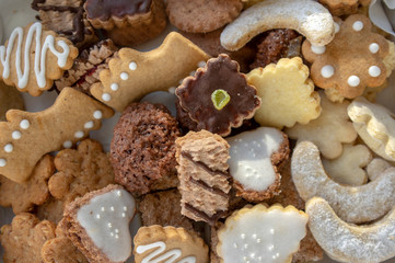 Many kinds of Christmas cookies in one pile in the box, various colors and tastes