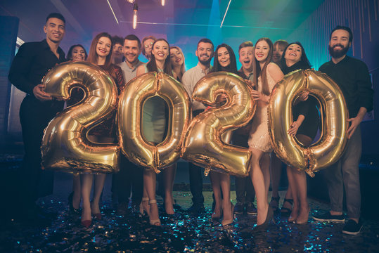 Photo of party life people crowd best friends holding big air balloons 2020 numbers newyear event wear formal wear luxury dresses shirts pants in night club