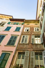Fototapeta na wymiar colorful small apartments with shutters in historical town Rovereto, Italy