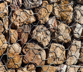 Stones in a metal grid as an abstract background