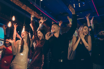 Photo of crazy chilling students dressed in formalwear putting their hands up rejoicing with party...