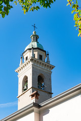 white tower with bells and weather cock. Rovereto, Italy