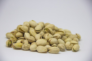 slide of pistachios on a white background. isolate