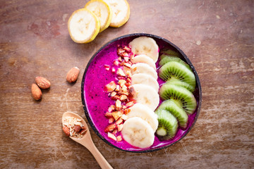 Smoothie bowl with fresh fruits,kiwi, banana and homemade granola almond for healthy vegan vegetarian diet breakfast.