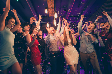 Photo of shouting overjoyed happy cheerful corporate people gathering standing in rain of confetti...