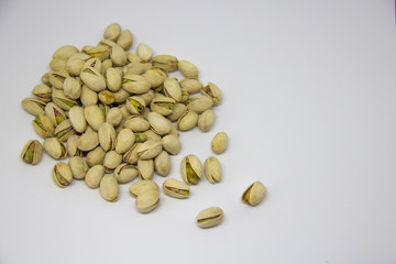 slide of pistachios on a white background. isolate