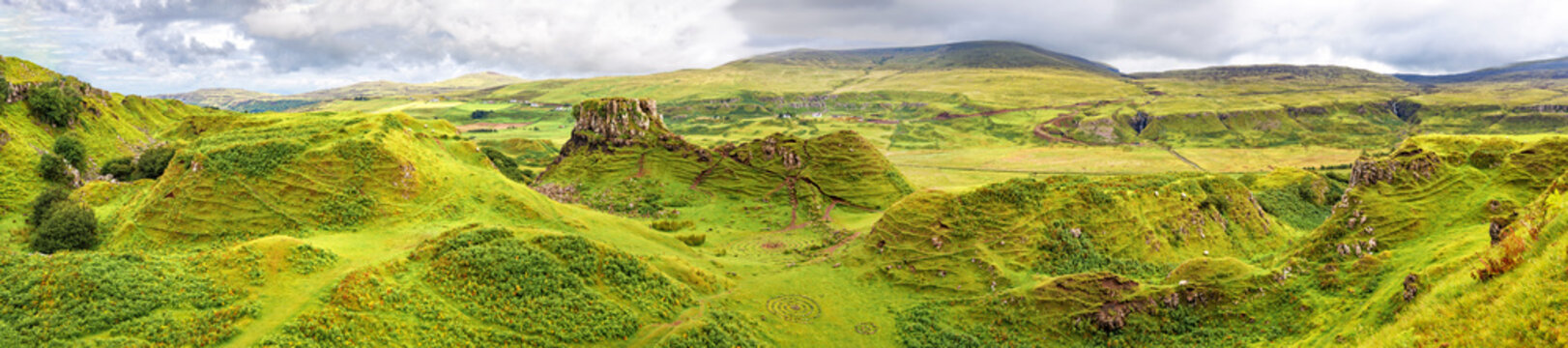 Panorama of famous mystic Fairy Glen, a green valley with romantic landscapes. Isle of Skye, Scotland.