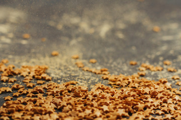  confectionery confetti in the shape of gold stars with space for text. decor for Christmas baking.