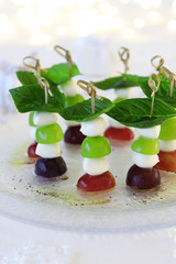 Grape caprese skewers on white christmas background
