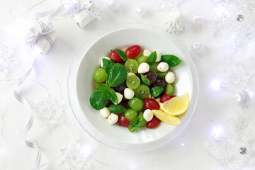 Grape caprese salad on white christmas background
