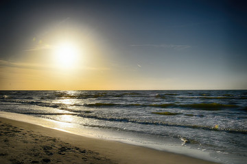 Fototapeta na wymiar orange sunset on the beach of the Baltic Sea in Poland