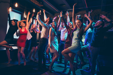 Full size photo of cheerful positive crazy group people company corporate college students have fun on disco dance feel rejoice indoors wear dress high-heels formalwear