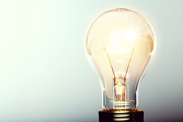 Glowing yellow light bulb, busienss idea concept