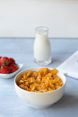 Sweet corn flakes  with milk and strawberry, breakfast. 