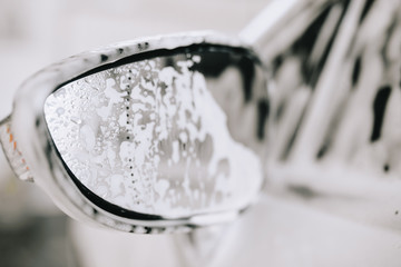 White car at the sink in the foam