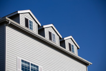 Fototapeta na wymiar Oregon Coast typical façades: wooden whingles, weathered, white windows. Pacific coast properties.